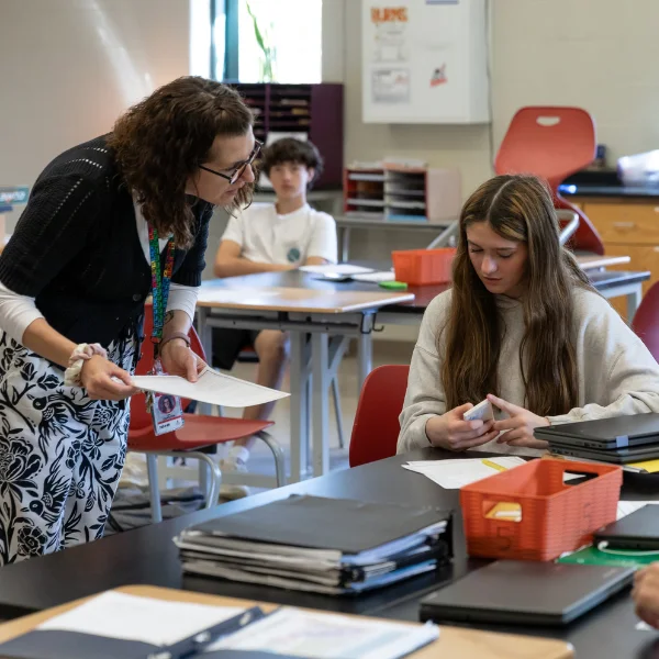 Teacher working with student on an assignment.